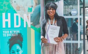 A former mentee showing off their Staf fMentoring Programme certificate