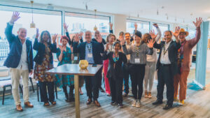 Image shows an open room with a large crowd of HDN's staff and associates
