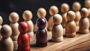 Stock image: A collection of wooden dolls, two of which are different colours to emphasise their diversity