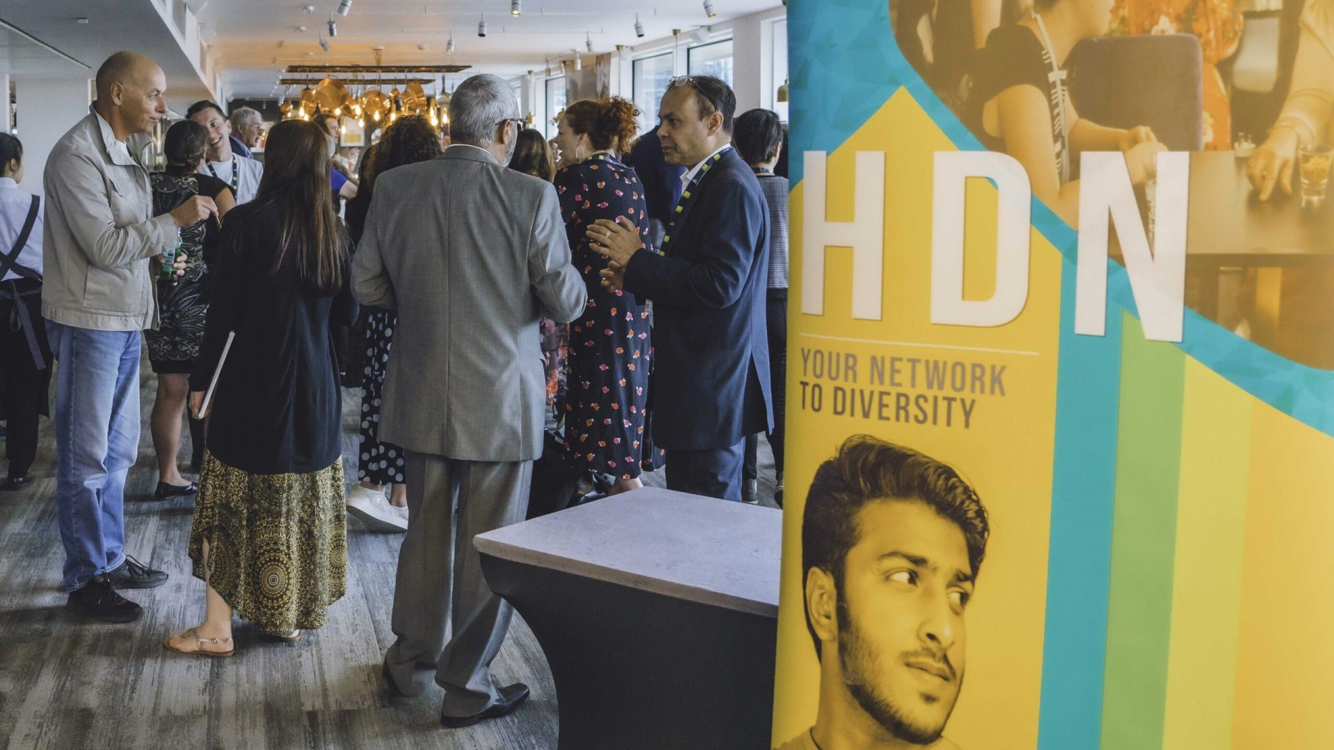 HDN Banner and a roomn full of people at out Board Diversity Conference(2024)